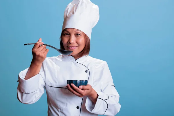 Munter Kokk Med Restaurantens Uniformsskål Med Matlaging Mens Smaker Maten – stockfoto