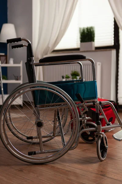 Wheelchair in empty room to provide mobility and support to people with chronic and physical disabilities. Auxiliary aid used to assist in transportation and accessibility.