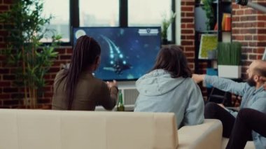Çeşitli arkadaşlar televizyonda video oyunu oynuyorlar, TV konsolunda oyun yarışmasının tadını çıkarıyorlar. Toplantının zorluklarıyla eğlenmek, hafta sonu eğlence aktiviteleri.
