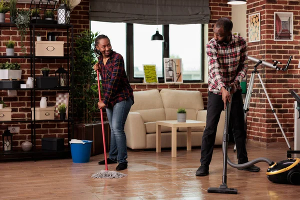 Happy Couple Doing Housework Talking Amused Vacuuming Mopping Floor Boyfriend — Stock Photo, Image