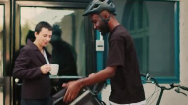 Restoran taşıyıcısı müşteriye fast food siparişi veriyor. Kadın da yiyecekleri çok akıllı ve NFC ile ödüyor. Erkek kurye, öğle yemeğini kese kağıdında getiriyor, yemek teslimatı için ödeme yapıyor. El kamerasıyla..