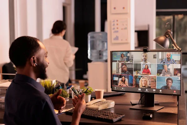 stock image Employee discussing startup plan with remote team on teleconference, talking with colleagues on online meeting. African american man attending videoconference, having corporate videocall