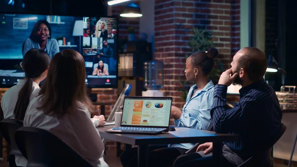 Employees greeting remote team in videoconference, company strategy discussion in teleconference. Diverse office workers chatting in online business meeting using videocall application