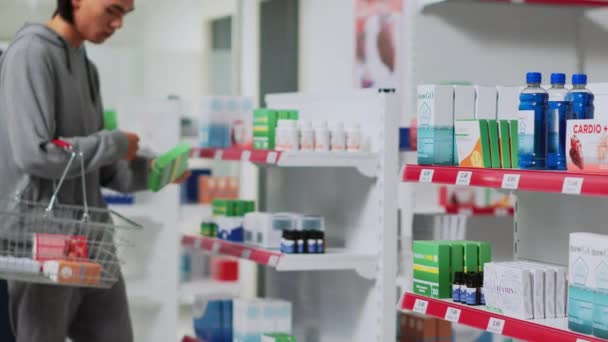 Young Man Taking Medicaments Pharmacy Shelves Putting Medical Products Basket — Stock Video