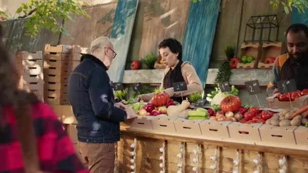 Разнообразные Поставщики Показывающие Красочные Фрукты Овощи Клиентам Местном Продовольственном Рынке — стоковое видео