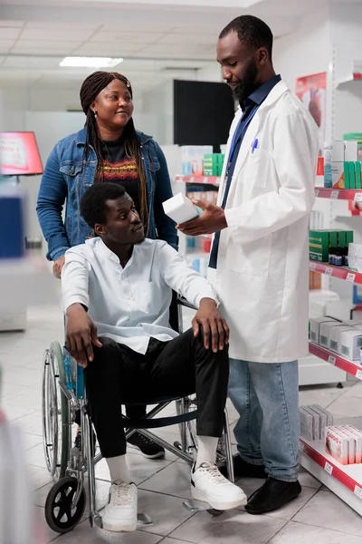 African American Pharmacy Consultant Helping Man Disability Choosing Nutritional Supplements — Stock Photo, Image