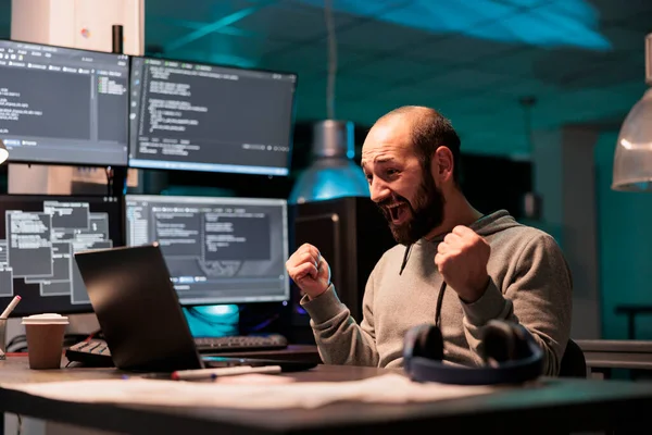 Happy software developer celebrating coding achievement, feeling pleased about app programming success after hours in office. Cheerful smiling coder enjoying victory, coding script.