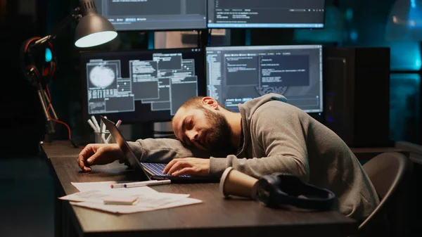 Male programmer falling asleep on office desk, feeling tired and trying to work on database server. Exhausted web developer being sleepy and yawning late at night, cloud computing.