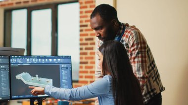 Yaratıcı 3D sanatçılar makine geliştirme hakkında tartışıyorlar, klemp prototipi üzerinde birlikte çalışıyorlar. Profesyonel grafik mühendisleri özel yazılım kullanarak endüstriyel motor ürünü geliştiriyor..