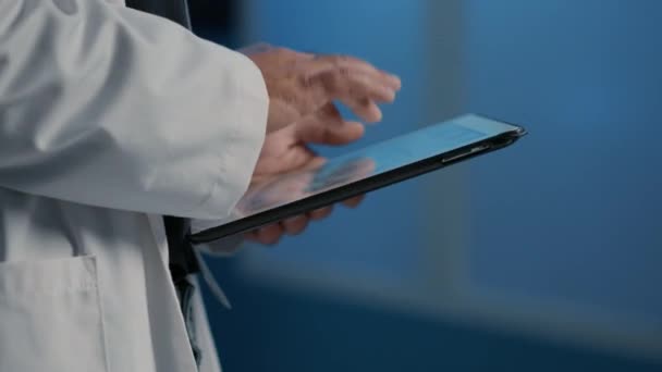 Close General Practitioner Holding Tablet Computer Searching Patient Disease Report — Vídeos de Stock