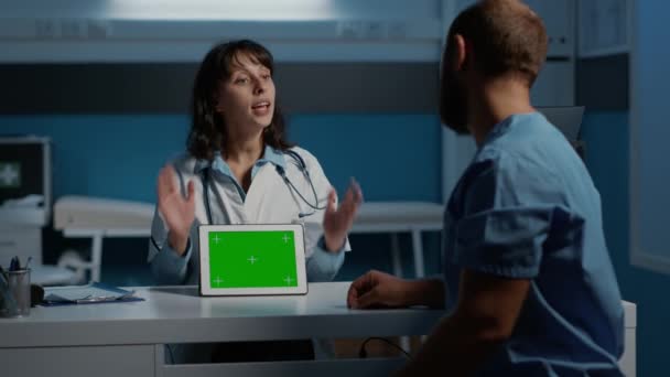General Practitioner Showing Medical Expertise Nurse Using Tablet Computer Green — Video
