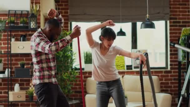 Life Partners Feeling Cheerful Dancing Cleaning Apartment Mopping Vacuuming Living — Vídeo de stock