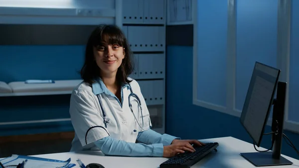 Portrait Smiling Practitioner Doctor Standing Desk Typing Medical Expertise Computer — Stock Photo, Image