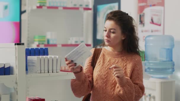 Woman Examining Drugstore Shelves Pharmaceutical Products Looking Prescription Treatment Buy — 비디오