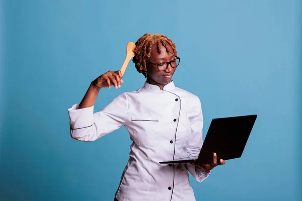 African American Smiling Woman Uniformed Professional Chef Searching Internet Computer — Fotografia de Stock