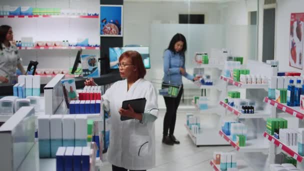 Female Specialist Using Digital Tablet Medicine Inventory Analyzing Pharmaceutical Products — 비디오