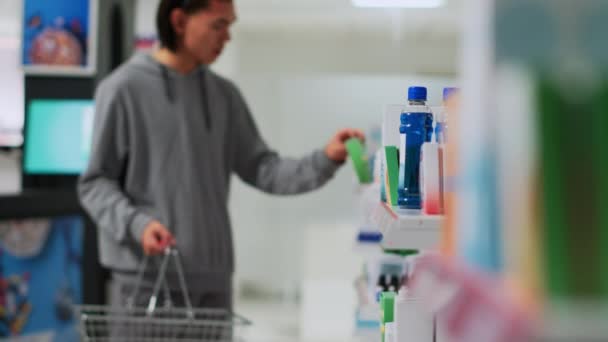 Male Customer Taking Medicaments Drugstore Shelves Putting Medical Products Basket — Vídeo de stock