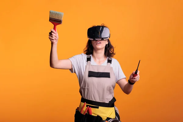 Woman Construction Worker Wearing Glasses While She Holds Paint Brush — Zdjęcie stockowe