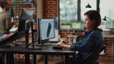 Man and woman brainstorming ideas to create new industry software on computer, looking at engine component. Office employees working on creative content production, professional job.