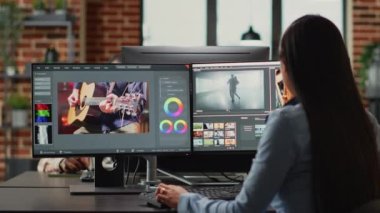 Graphic designer creating professional movie content with filmmaking software in agency office, creative digital film. Cinematographer editing video footage with lighting and focus, videography.