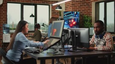 Employee game developer working in creative production department to create professional web content in office. Asian woman developing 3D graphics components with engineering software