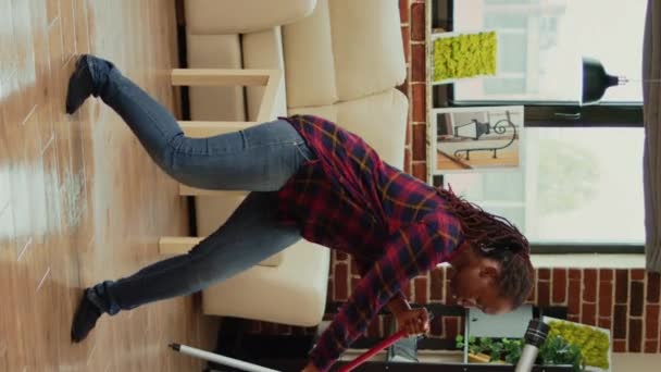 Vertical Video Cheerful Girlfriend Dancing Apartment Using Mop Sweep Floors — Stockvideo