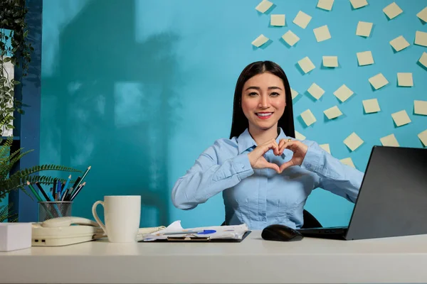 Friendly Professional Woman Making Heart Shaped Sign Indicating Positivity Love — Zdjęcie stockowe