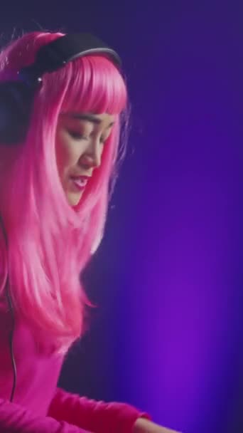 Vertical Video Pink Hair Mixing Electronic Sound Using Mixer Console — Stockvideo