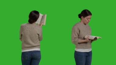 Young person with action book reading in studio, enjoying novel chapter with story. Caucasian woman standing over isolated greenscreen backdrop, read tale on camera as leisure activity.