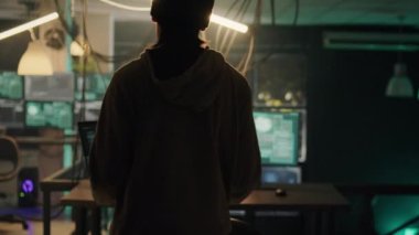 Hackers working at night to break firewall encryption on multi monitors, trying to steal government data for hacktivism. Team of criminals hacking network system server with trojan virus.