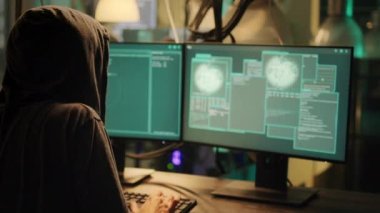 Cheerful man celebrating espionage achievement on monitors, feeling happy about stealing passwords at night. Skilled hacker enjoying cyberattack success with malware to break firewall.