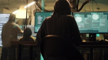 Skilled spy celebrating hacking achievement with security breach, attacking goverment system with encryption. Hacker committing identity theft, cryptojacking ransomware. Handheld shot.