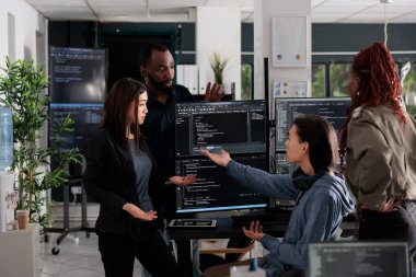 Multi ethnic web developers writing script while talking about develop cloud computing server. IT engineers having unexpected server error and no access to database, hacking attack.