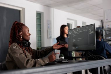 Smiling software developer programming server code algorithm on computer, typing sever data in big data office. Database engineer working on new user interface with online system to create algorithm.