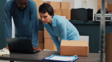 Diverse team of people checking supply chain on warehouse shelves, planning shipping and storage management. Young owners working on business development and logistics, stock distribution.