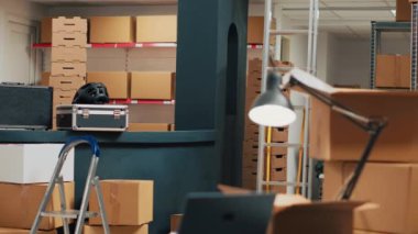 Empty storehouse space with cardboard boxes on shelves and racks, shelving merchandise before shipping it to clients. Warehouse filled with supplies and packages, wholesale management.