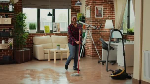 Happy Woman Dancing Living Room Using Mop Clean Floors Listening — Vídeo de Stock