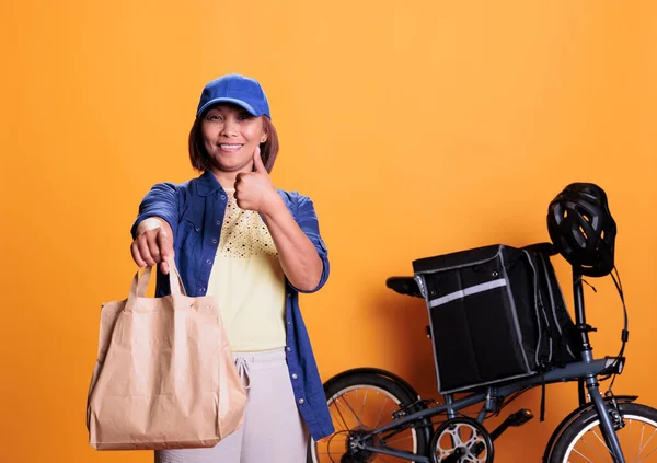 Smiling Deliverywoman Doing Thumbs Gesture While Delivering Take Away Food — Foto Stock