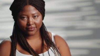 Glowing cheerful person being confident on camera, showing self love and self acceptance in studio. Flawless beauty model expressing body positivity at skincare campaign, radiant skin.