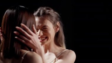 Happy confident women hugging on camera to promote body and skin diversity, advertising skincare and femininity campaign. Beautiful ladies feeling positive and flawless in studio.