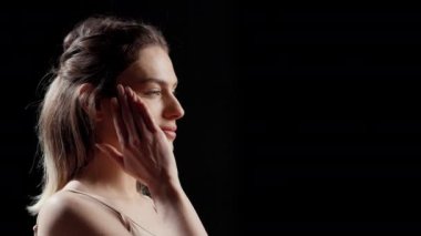 Woman with glamourous style doing beauty campaign and posing on camera for skincare products ad. Young female model acting confident and gentle, being sensual with beauty routine.