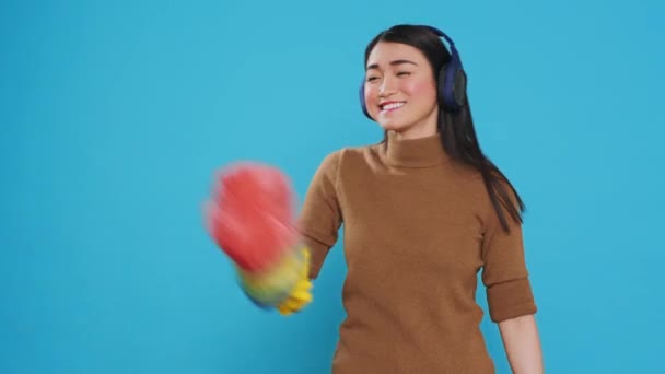 Cheeful Housekeeper Wearing Headphones While Dancing Having Fun House Cleaning — Stockvideo