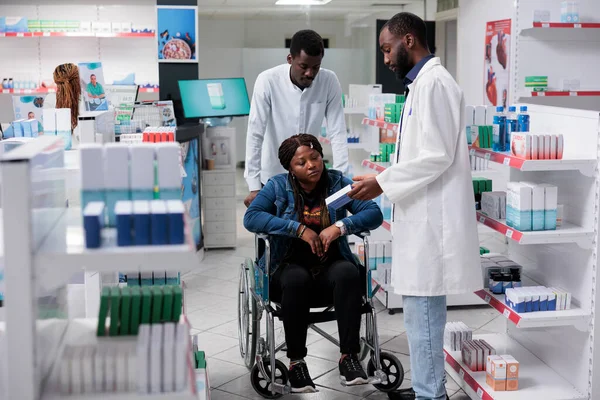 African American Woman Disability Shopping Drugstore Pharmacist Recommending Medicaments Medications — Stockfoto