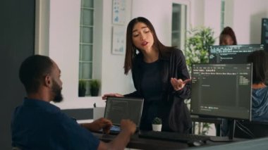 Diverse database developers doing highfive gesture with colleague programer, analyzing compiling code on computer. System engineers celebrating successful data server coding, artificial intelligence.