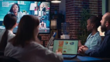 Employees talking with remote team in videoconference, coworkers discussing company strategy in teleconference. Diverse office workers chatting in online business meeting using videocall app