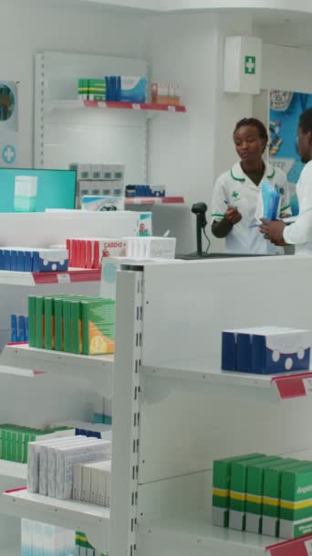 Vertical Video African American Pharmacist Putting Medication Racks Drugstore Arranging — Stock videók