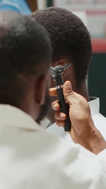 Vertical Video Pharmacy Worker Consulting Man Otoscope Tool Otologist Doing — стокове відео