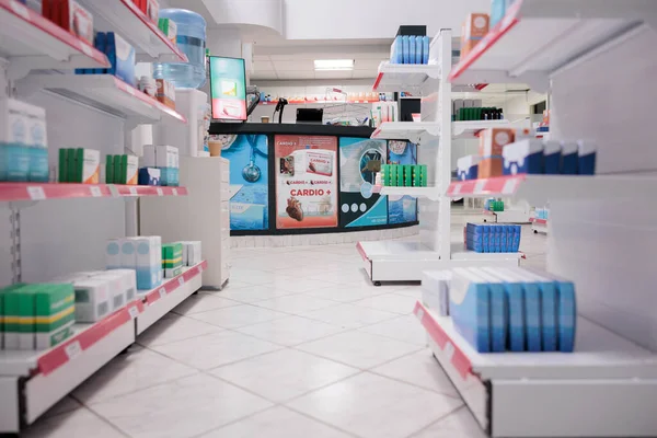 Empty health care facility shelves filled with vitamins and medicaments boxes, retail store with pharmaceutical products. Pharmacy space equipped with medical drugs and pills, supplement bottles.