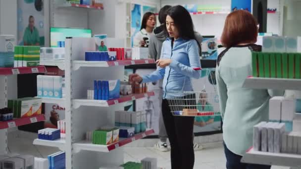 Female Customer Reading Prescription Pills Boxes Looking Medicaments Supplements Pharmacy — 图库视频影像