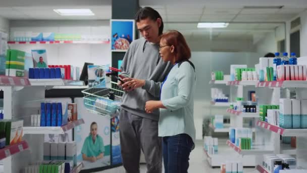 Asian Worker Reading Prescription Smartphone Give Medicine Client Explaining Healthcare — Video Stock